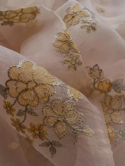 This embroidered organza with golden floral details is the epitome of dreamy elegance, perfect for creating magical occasion wear.