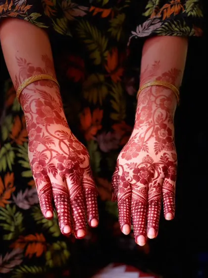 The back of the hands showing a beautiful, even stain. The floral and vine patterns have developed into a lovely deep red color.