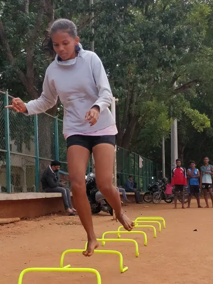Here, one of our dedicated athletes performs barefoot plyometric jumps over hurdles. Training on the natural ground like this builds stronger feet and ankles, giving you a solid and more resilient foundation.