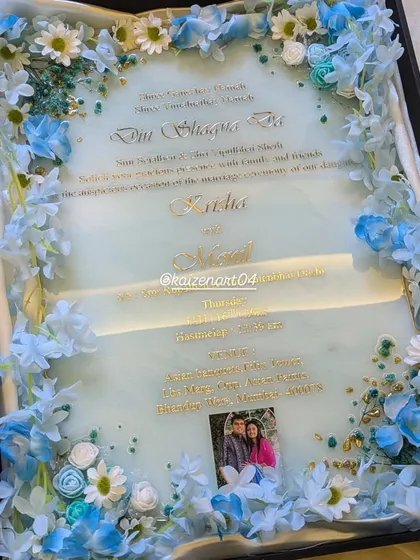 A full view of the custom blue and white themed wedding Kankotri. The combination of dried and artificial flowers with the resin art creates a stunning multi-dimensional effect.