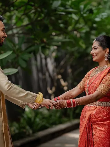 A quiet, intimate portrait framed by lush greenery. We use natural elements to create a sense of romance and tranquility in our couple's wedding photos.