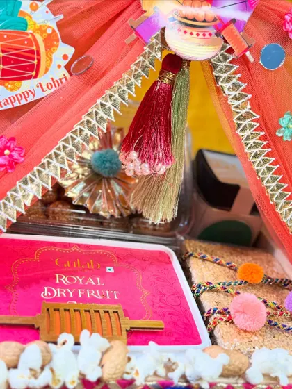 A close-up of the canopy-style Lohri hamper, showing the details like the mini belan (rolling pin) and popcorn accents.