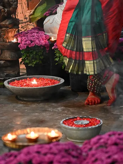A moment of cultural grace from our festive celebration, with a dancer's feet next to stone uralis filled with flowers. This is the atmosphere I strive to create, one inspired by the rich traditions of India.