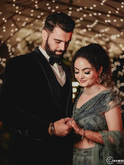 An intimate close-up of the couple during their engagement. The warm lighting and their close embrace create a feeling of romance and connection.