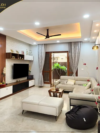 Another view of the cozy living room, showing the arrangement of the sectional sofa, ottoman, and bean bag, creating a relaxed and inviting atmosphere.