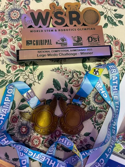 Trophies and medals used as visual aids for a speech. We teach students to use personal achievements to make their presentations more engaging and authentic, connecting their life experiences to their exam work.