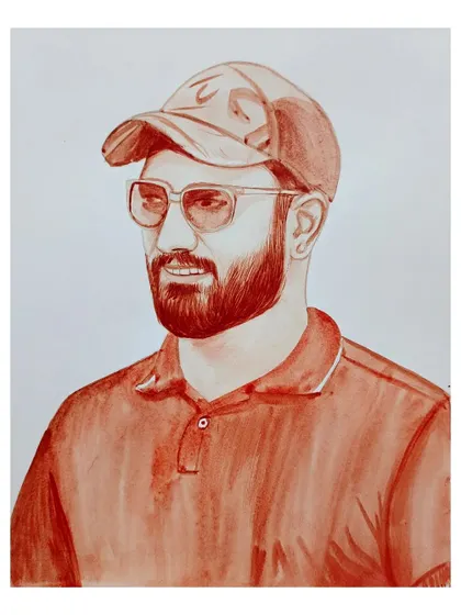 A casual blood portrait of a man with a beard, wearing a cap and glasses.