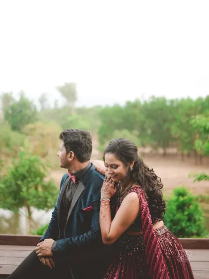 A quiet, romantic moment during the Sangeet. The couple sits together, sharing a private smile away from the crowd.