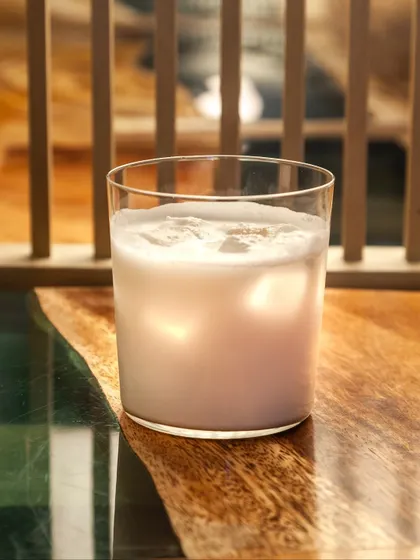 A creamy, dreamy glass of our Lemongrass Pina Colada, made with roasted almond orgeat, cream, and fresh pineapple.