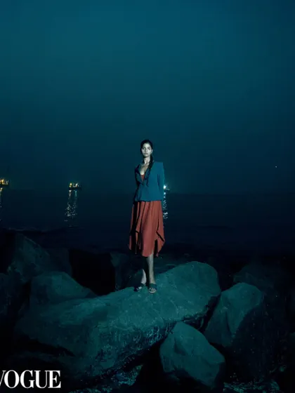 A moody, atmospheric shot taken at dusk, published in PhotoVogue. This image blends fashion with a cinematic, narrative quality.