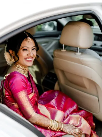 The bride on her way to the ceremony. Her smile is infectious, and her makeup and hair are perfectly set for the big day.