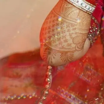 A macro shot of the intricate mehndi design on the bride's arm. We appreciate and document the artistry of every element of your wedding.