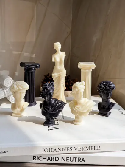 The full set of my black and white wick-less Roman sculptures. The collection includes busts of Venus, Apollo, and David, as well as architectural pillars.