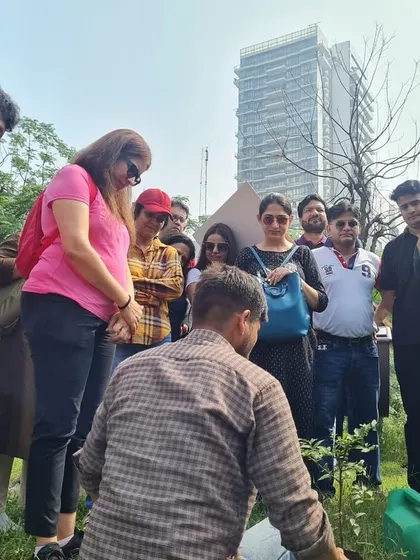 The NatWest team learns how to properly plant a sapling, a key part of our effort to revive the shrinking Ghata Bundh and improve its water catchment capacity.