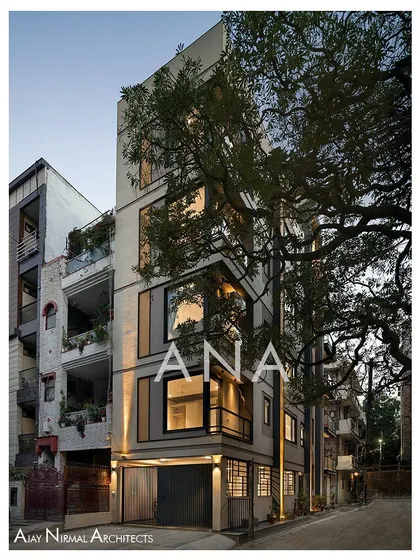 The corner of the Yellow Line Apartment building, where the front and side facades meet. The design uses large corner windows to open up the interior living spaces to the exterior.