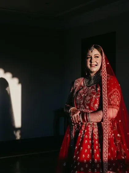 Using light and shadow to create a dramatic and artistic bridal portrait. The silhouette in the background adds a layer of depth and storytelling to the image.