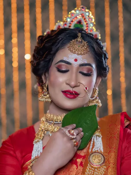 For my Bengali brides, I love creating this iconic look. It features bold, expressive eyes, a classic red lip, and the traditional Mukut and bindi design, all coming together to create a look of pure elegance and cultural pride.