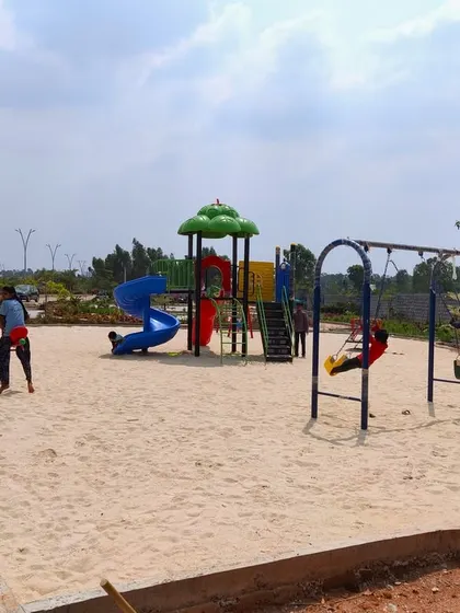 The children's play area at 'The Sanctuary' under construction, with the see-saw and slide already installed in the sand pit.