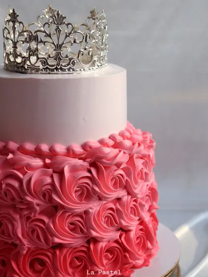 A close-up on the intricate silver crown that tops this stunning princess cake.
