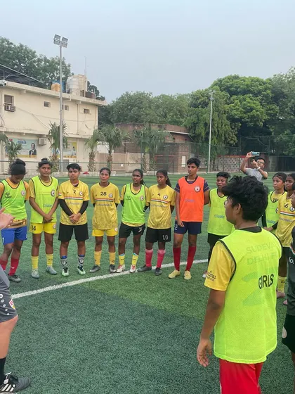 A VfB coach speaks to the girls' team, providing encouragement and technical feedback. We are dedicated to nurturing the next generation of female football stars in a professional environment.