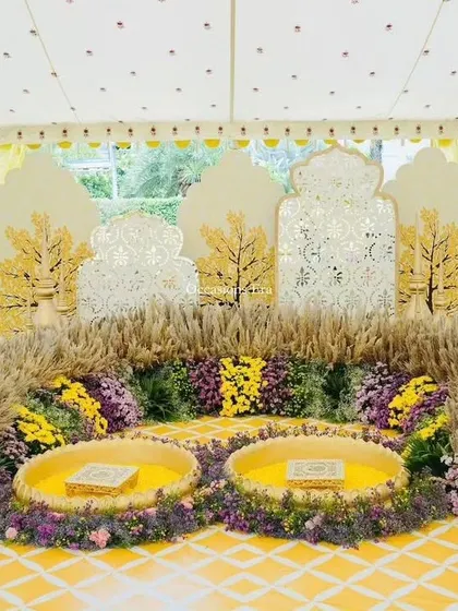A beautiful Haldi or Mehendi ceremony setup. We used fragrant pampas grass, yellow florals, and intricate cutout backdrops to create a sunny and joyful space for pre-wedding rituals.