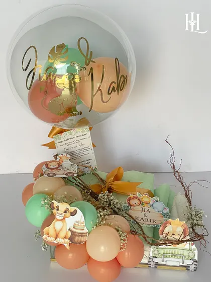 A safari-themed 3rd birthday hamper for Jia and Kabir. This gift features a personalized balloon, a custom greeting card, and adorable Lion King themed decorations, along with a selection of fun and age-appropriate presents.