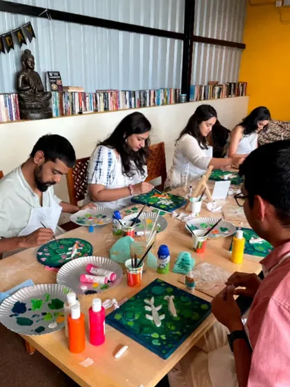 A group of artists working on their Koi Fish paintings. The workshop is a great social event, bringing together people who share a love for art.