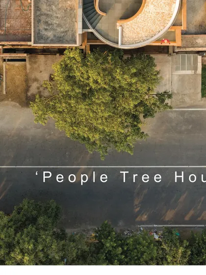 A close-up aerial view highlights the relationship between the People Tree House and its namesake, the Peepal tree. The design was conceived to honor and interact with this existing natural element, making it the true heart of the project.