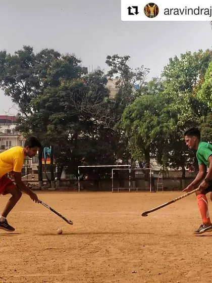 A powerful action shot of two of our players in a one-on-one battle, capturing the intensity and spirit of grassroots hockey.