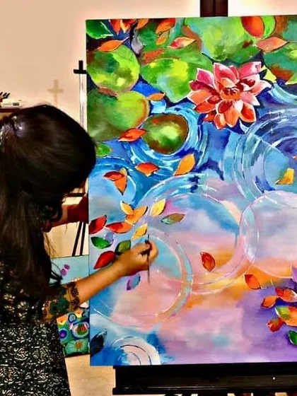 It's never too late to find your inner artist. This student is creating a beautiful, vibrant lotus pond painting, finding her moment of peace and focus in my adult art class.