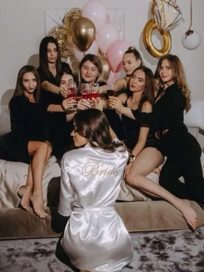 The bride in her satin robe surrounded by her best friends. This is a classic, must-have photo for any bachelorette or bridal shower.