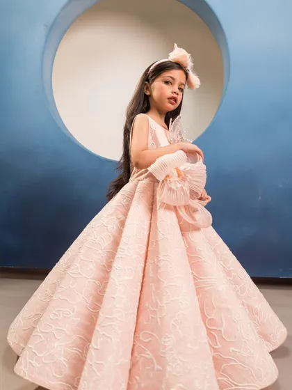 This side view shows the volume and structure of the pink brocade gown, fit for royalty.