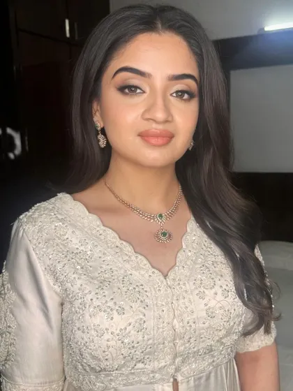 A close-up of Shravya's elegant makeup, highlighting the clean lines and soft colors.