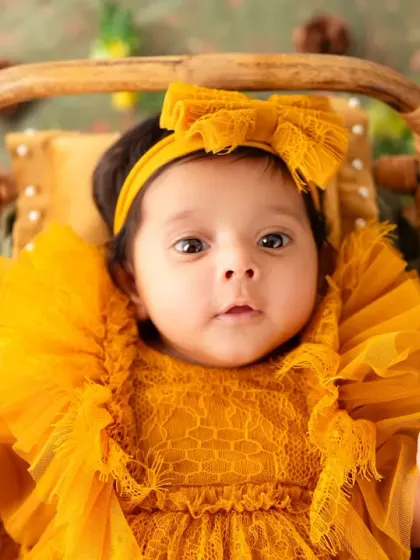 A curious and wide-eyed look from this adorable baby, captured in our nature-themed setup.