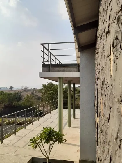 The deck at Ranch House in progress, showing the contrast between the rough basalt stone wall and the smooth concrete floor.