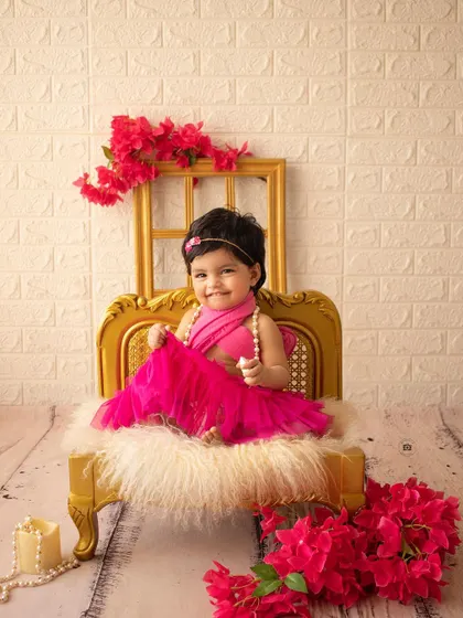 A happy smile from the birthday girl during her vibrant, pink-themed photoshoot.