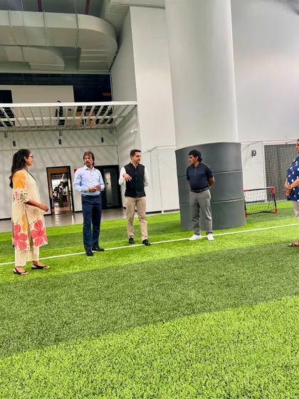 Hockey legends Dhanraj Pillai and Arjun Halappa tour our indoor football arena with our leadership team.