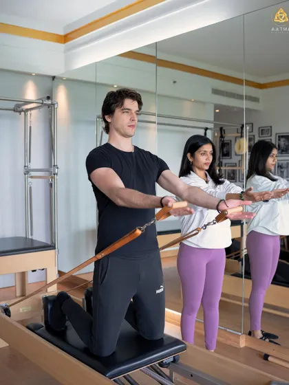 Teaching is a partnership. In this private session, I'm ensuring the client maintains proper form and engagement as he works with the resistance of the Reformer springs.