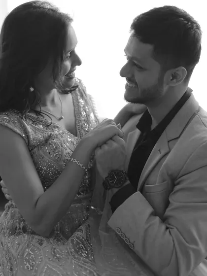 A happy, interactive moment between the couple, captured in beautiful monochrome.