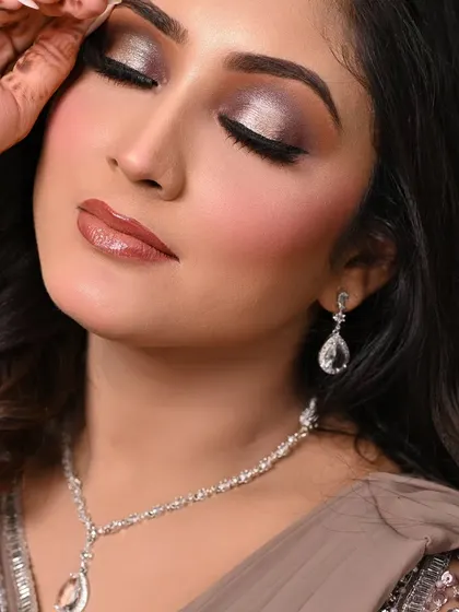 A soft and shimmery party look. The silver and taupe eyeshadows create a sophisticated smokey effect, perfect for a cocktail or reception event.