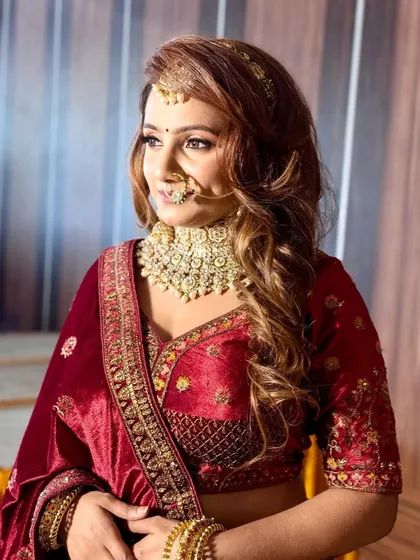 A candid shot of this beautiful reception bride. Her makeup features warm, golden tones and a defined eye, perfect for her opulent outfit.