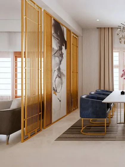 This view showcases the elegant gold-finished metal and glass partition we used to define the dining area. It separates the space while maintaining an open, airy feel, complemented by the abstract art panel.