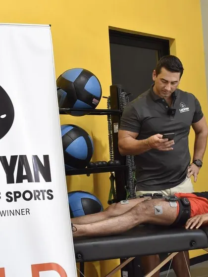 Our Head of Athletic Performance, Dr. Wayne Lombard, uses advanced equipment to assess an athlete's muscle activation and strength. This data-driven approach is central to our training philosophy.