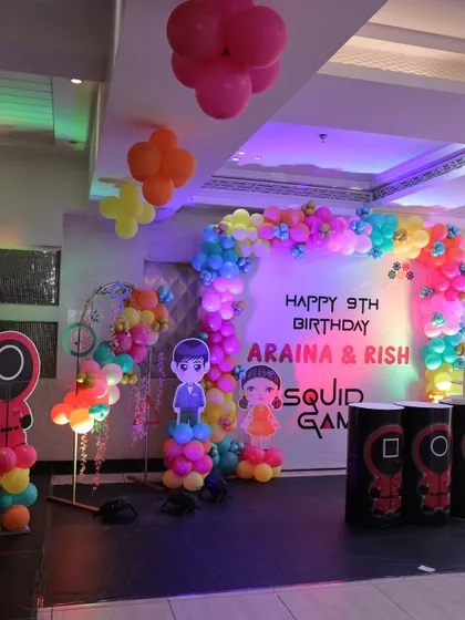 The main stage for the 'Squid Fiesta' birthday, featuring character cutouts, a vibrant balloon arch, and custom-designed props. This served as the central point for the cake cutting and other activities.