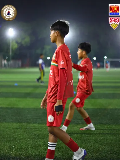 Players on the pitch during a night training session. The dedication to improve doesn't stop when the sun goes down. Our floodlit grounds allow for training at all hours.