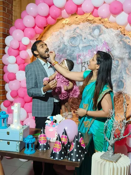 The cake-cutting moment at Mishka's moon-themed first birthday. These happy, interactive moments are what celebrations are all about.