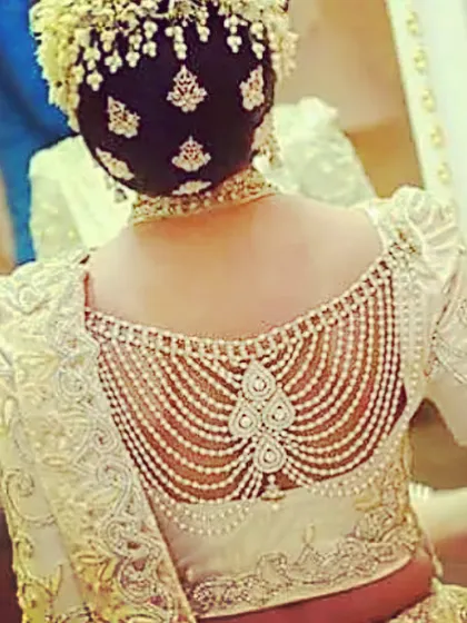 For a truly grand look, I can create blouses with elaborate pearl and stonework detailing on the back. This is a popular style for bridal blouses and formal occasions.