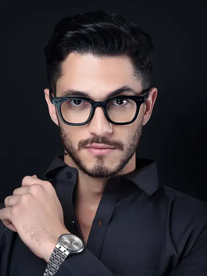 A sharp, confident portrait of a male model wearing a watch, suitable for a men's accessories or lifestyle brand.