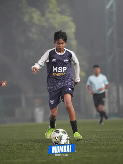 Dribbling through the morning mist, a player shows dedication in all conditions.