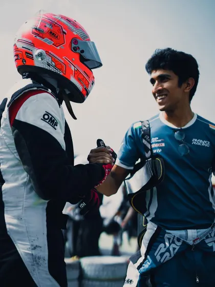 A handshake between teammates after a competitive race. We encourage healthy competition and mutual respect among all our drivers.